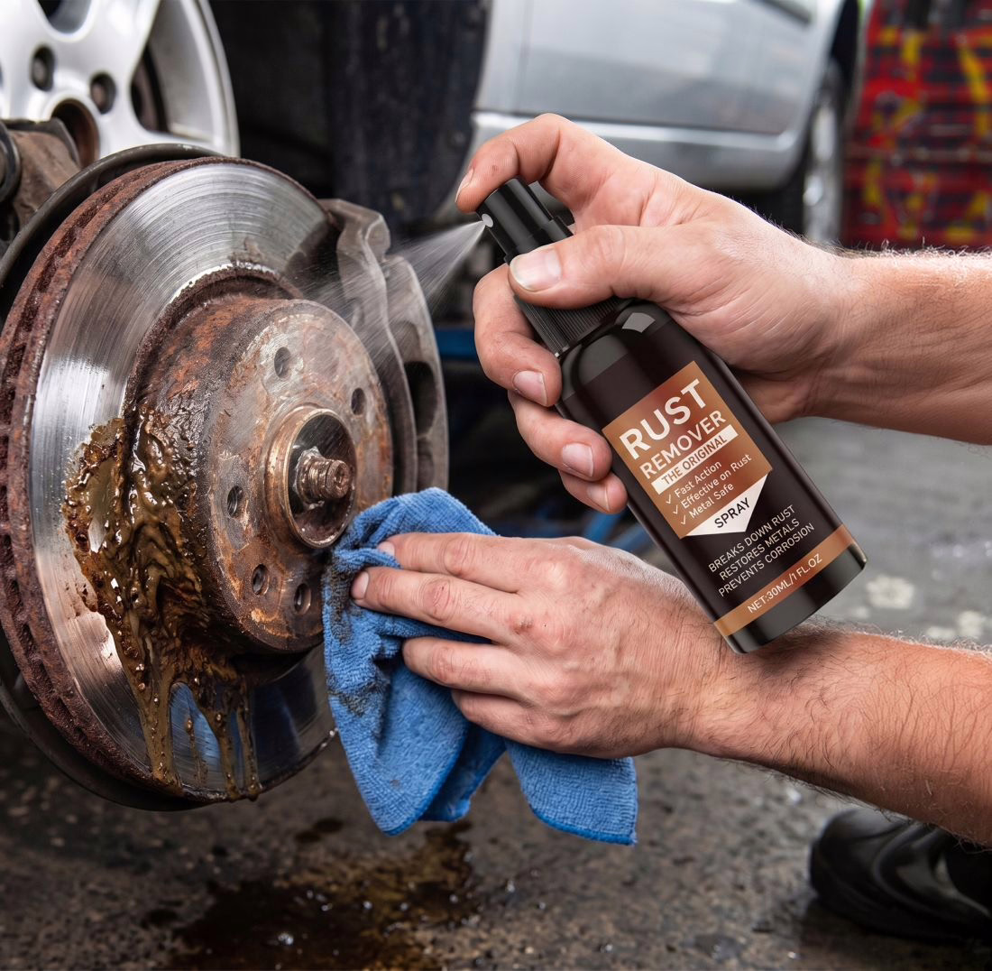Two hands cleaning a rusted brake disc with the product and a cloth